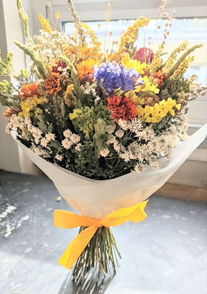 A dried-flower bouquet tied with yellow ribbon