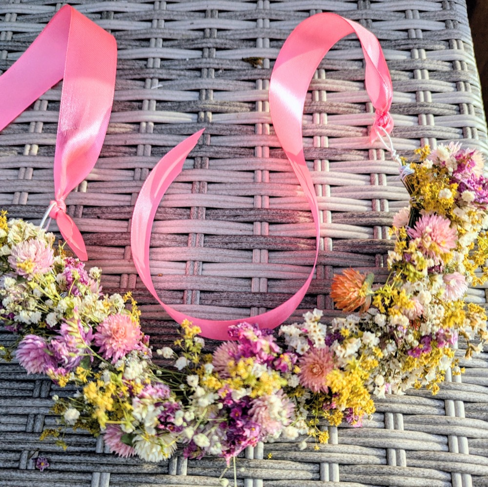 A dried-flower crown with ribbon