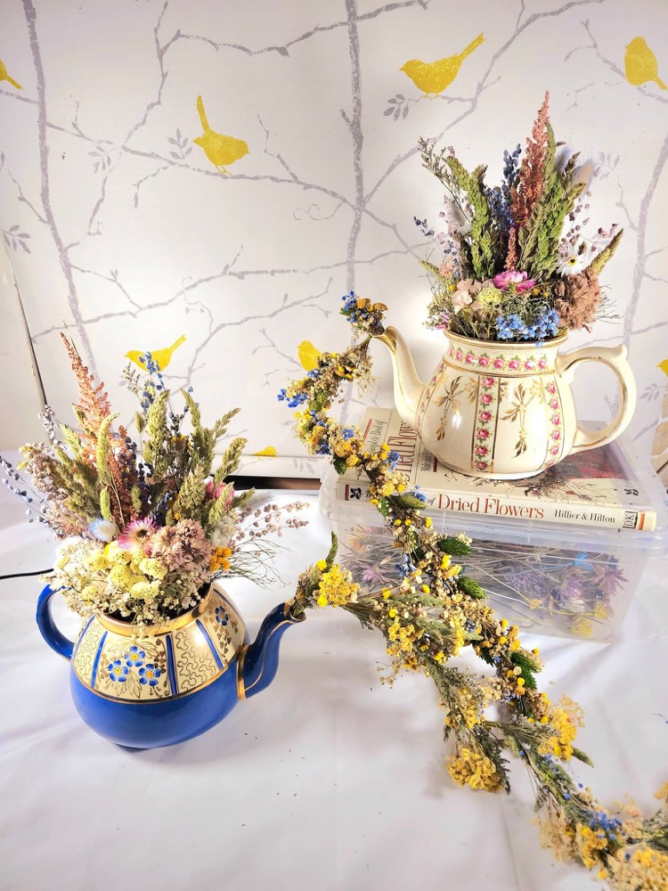 Dried flowers arranged in vintage teapots